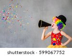 Let's party! Funny kid clown. Child speaking with megaphone. 1 April Fool's day concept