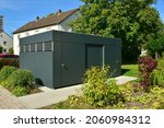 Small photo of Modern Metal Tool Shed, Bike Shed or Garden Shed or Garbage collection system with in Front of a residential building
