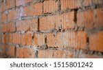 Small photo of he moistening the surface before applying plaster. The process of priming a brick wall. A primer solution is applied to a brick wall using a roller thus and so to remove dust and increase adhesion