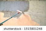 Small photo of The process of priming a brick wall. A primer solution is applied to a brick wall using a roller thus and so to remove dust and increase adhesion. Processing of brickwork by priming. T