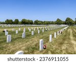 Small photo of Minneapolis, Minnesota, USA - May 27, 2023: Landscape view of soldier gravestones at Fort Snelling National Cemetery on a clear day.