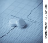 Small photo of Cardiogram and nitroglycerin, the concept for strokes and heart attacks