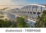 Small photo of Rajghat bridge on the river Ganges at sunrise. Also known as the Malviya bridge it is a double decker bridge with rail tracks on the lower tier and vehicle road on the upper tier.