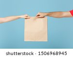 Close up cropped hands hold brown clear empty blank craft paper bag food for takeaway isolated on blue background. Packaging template mock up. Delivery service concept. Copy space. Advertising area