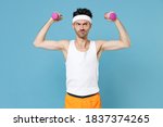 Confused young strong sporty fitness man with thin skinny body sportsman in white headband shirt shorts doing exercise with dumbbells isolated on blue background. Workout gym sport motivation concept