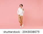 Full length young employee business woman corporate lawyer in classic formal white shirt work in office hold takeaway delivery craft paper brown cup coffee to go isolated on pastel pink background.