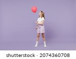 Small photo of Full length little kid girl 12-13 year old in white shirt celebrate birthday holiday party hold colorful air inflated helium balloon isolated on purple background Childhood children lifestyle concept
