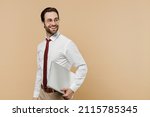 Young happy successful employee business man corporate lawyer 20s in white shirt red tie glasses work in office hold use laptop pc computer look aside on workspace isolated on plain beige background