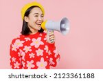 Small photo of Smiling happy woman of Asian ethnicity 20s wear red knitted sweater beret hold scream shout in megaphone announces discounts sale Hurry up isolated on plain pastel pink background studio portrait.