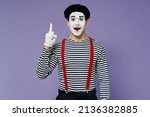 Small photo of Insighted smart proactive fun young mime man with white face mask wears striped shirt beret holding index finger up with great new idea isolated on plain pastel light violet background studio portrait