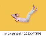 Full body side view young woman she wears purple pyjamas jam sleep eye mask rest relax at home fly up hover over air fall down on pillow isolated on plain yellow background studio. Night nap concept