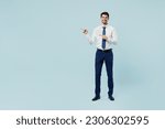 Small photo of Full body young employee IT business man corporate lawyer wear classic formal shirt tie work in office point index finger aside indicate on area isolated on plain pastel light blue background studio