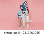 Small photo of Full body young parents mom dad with child kid daughter teen girl in blue clothes celebrating birthday holiday party hold bunch inflated helium balloons hug isolated on plain pastel pink background.