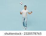 Small photo of Full body sideways fun happy young man fan wear t-shirt cheer up support football sport team toss up soccer ball watch tv live stream do winner gesture isolated on plain pastel blue color background