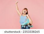 Small photo of Overjoyed elderly blonde woman 50s years old she wearing blue undershirt casual clothes do winner gesture hold roller bladers isolated on plain pastel light pink background studio. Lifestyle concept