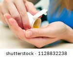Small photo of Woman pouring bunch of prescription yellow opiate pills into hand