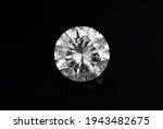 Round diamond faceted cubic zirconia, cubic crystalline form of zirconium dioxide (ZrO2) colorless synthesized material. White synthetic gemstone. Diamond imitation. Black isolated background.