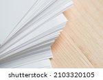 Small photo of Stack of clean sheets paper, laid out randomly in wooden background. Abstract background of paper sheets