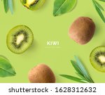 Creative layout made of kiwi and leaves. Flat lay. Food concept. Kiwi on green background.