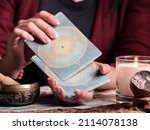 Small photo of A close up of a female tarot reader shuffling tarot cards