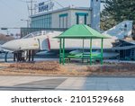Small photo of Pohang, South Korea; December 21, 2021: Decommissioned Phantom F4 aircraft beside green gazebo in public park