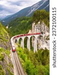 Swiss red train on viaduct in...