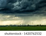 Small photo of Dramatic thundercloud over a wheat field wih the city of Frankfurt in the distance, Germany