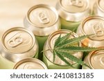 A collection of aluminum cans with a cannabis leaf. Trending concept of CBD-infused beverages with hemp. Eco-friendly packaging and wellness industry.