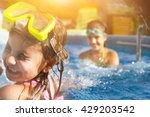 Children playing in pool. Two little girls having fun in the pool. Summer holidays and vacation concept