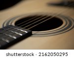 Meatal acoustic guitar strings in closeup. Professional musical instrument for guitarist. Curated collection of royalty free music photos and images for poster and wallpaper design