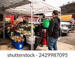 Small photo of Pittsburgh, PA USA - 4 2 2022: Sidewalk flower vendors line the bustling streets of Pittsburgh's Strip District, offering a colorful array of blooms to passersby.