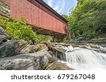 Small photo of Built in 1887, the historic Packsaddle Covered Bridge crosses over a waterfall on Brush Creek in rural Somerset County, Pennsylvania.