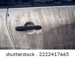 Dirty exterior door handle of vehicle. Dirty white car side view. Texture of mud on white car. Dirty SUV car after  adventure on messy road. Car wash concept