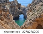 Algarve, Portugal, rock arch in water, Ponta da Piedade rock formations. Travel destination in Europe.