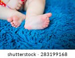 Closeup of child feet on blue carpet