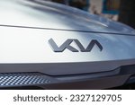 Small photo of Yerevan, Armenia, 04 July - 2023: KIA Motors, new angular logo on the hood of white Kia SUV. Chrome KIA logo closes up a hood, front grill, and bumper detail