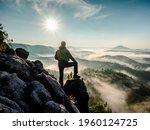 Single man hiker on a mountain trail. Mountain look into misty valley