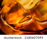 Whisky on the rocks, glass filled with ice cubes, close-up shot