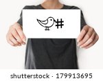 Social media hashtag twitter. Female in black shirt showing or holding a card