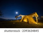 Small photo of Outdoor camping tent with tarp or flysheet over mountain