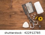 Sewing accessories on wooden background
