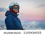 Portrait of a male skier on the mountain at sunset