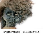Small photo of Damn doll: scary, sinister nightmare doll, in a dark basement doll toy girl very horrible appearance. Ghastly dreams, toy for Halloween on white isolated background.