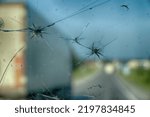 Highway through a broken windshield after encountering truck with crushed stone. Challenging driving on Asian roads. Small stones fly out from under wheels of heavy trucks or when gravel transporting