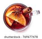 Glass of hot mulled wine with spices isolated on white background. Top view
