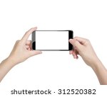 Female hands taking photo with smart phone of blank white touch screen, front view, isolated on white.