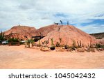 Small photo of COOBER PEDY, SA, AUSTRALIA - NOVEMBER 14: Outside Crocodile Harry's underground home with cacophonous collection of art, decorations and messages, on November 14, 2017, Coober Pedy, Australia