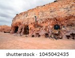 Small photo of COOBER PEDY, SA, AUSTRALIA - NOVEMBER 14: Outside Crocodile Harry's underground home with cacophonous collection of art, decorations and messages, on November 14, 2017, Coober Pedy, Australia