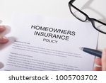 Close-up Of Homeowners Insurance Policy Form And Spectacles