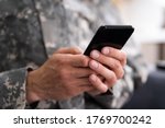 Social Cyber Warfare. Army Soldier Using Smart Phone